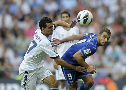Real Madrid defender Alvaro Arbeloa (R) fights for the ball with Valencia's forward Roberto Soldado (L)